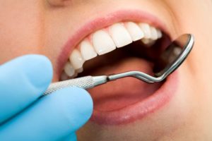 Dentist checking patient's teeth