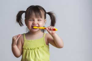 Small girl brushing her teeth