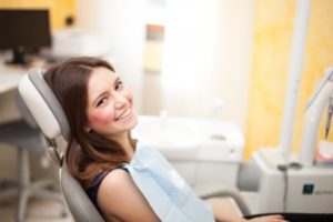 woman sitting on a dentist chair and smiling