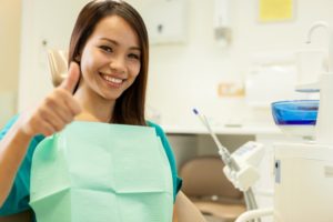 Smiling Asian woman sitting at the dentist