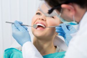 Dentist checking woman's teeth