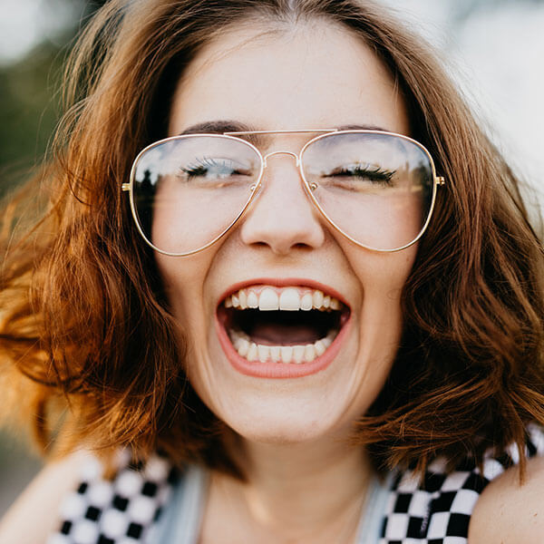 happy young woman smiling at the camera