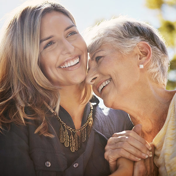 happy senior woman spending quality time with her daughter outdoors