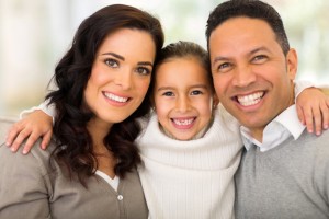 Pretty little girl hugging her parents