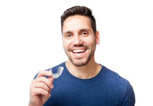 Man holding invisalign braces