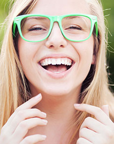 Young girl wearing spectacles and smiling